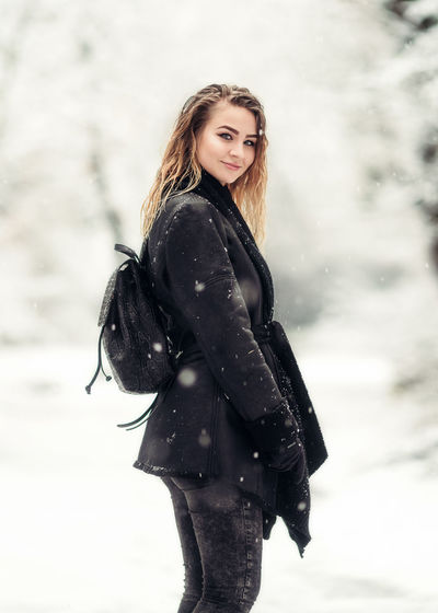 Portrait of a woman standing in snow
