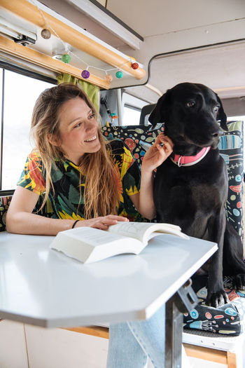 Woman traveling with dog in camper van