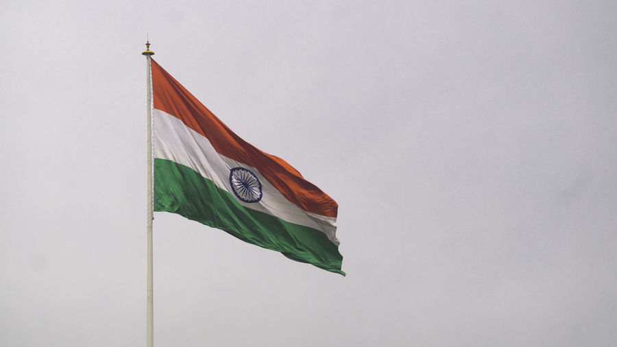 Low angle view of indian flag against sky