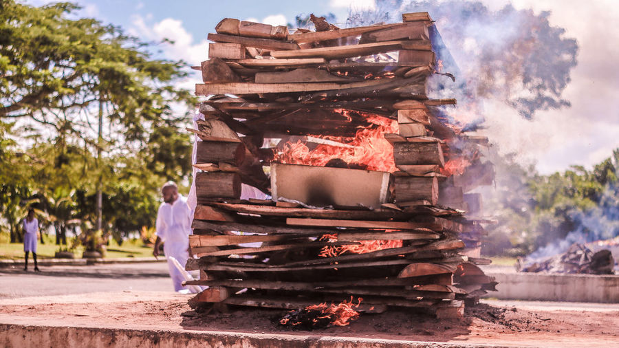 Stack of wood burning outdoors