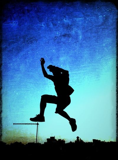 Low angle view of silhouette woman jumping