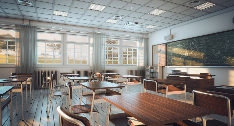 Empty chairs and tables in classroom