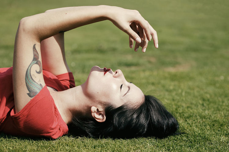 Young woman lying on field