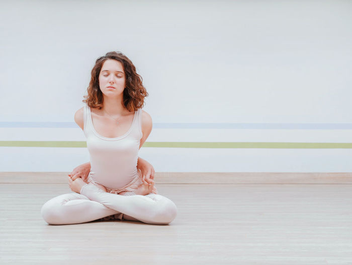 Young woman meditating in yoga studio