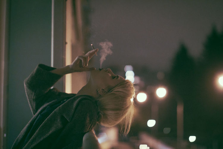 Woman smoking at night