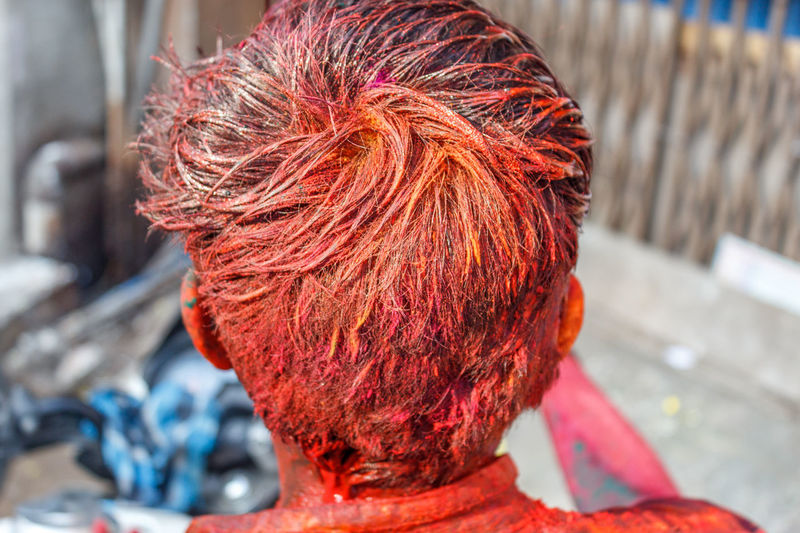 Rear view of man with color during holi