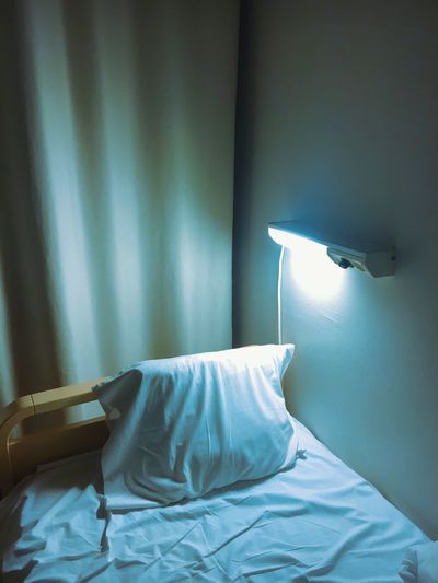 High angle view of bed by lighting equipment