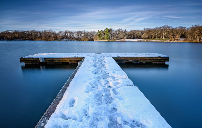 Scenic view of frozen lake against sky
