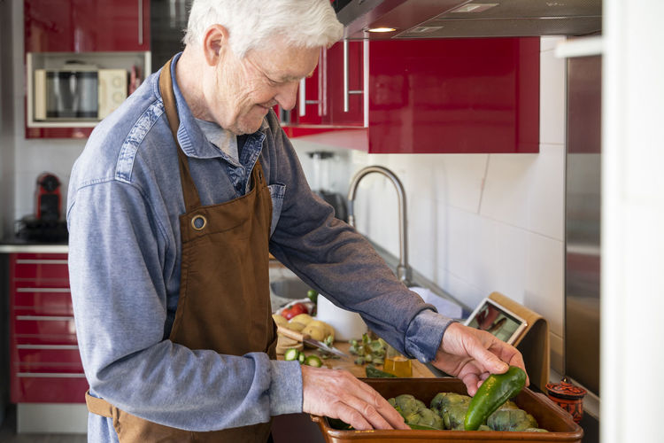 Midsection of man preparing food at home