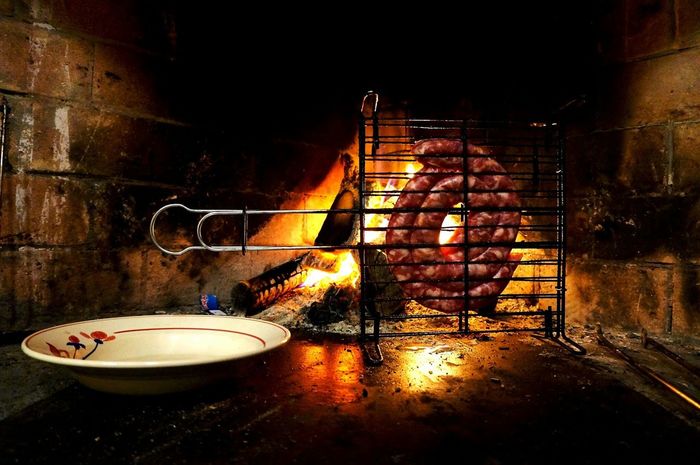 Meat on metal grate cooking in oven