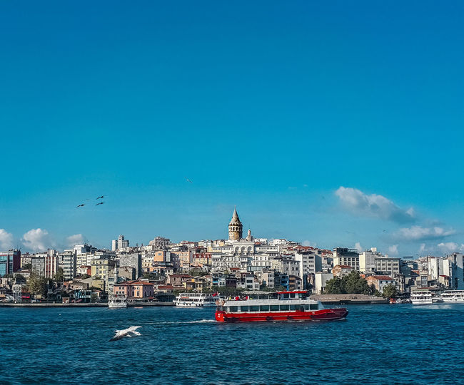 View of boats in sea against buildings