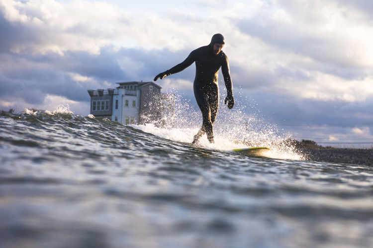 Man surfing winter day at sunset