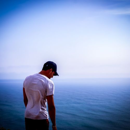 Man looking at sea against sky