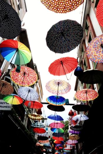 Low angle view of umbrellas hanging at market stall