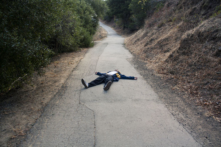 Man lying on road