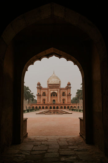 Exterior of safdarjungs tomb sandstone and marble mausoleum in new delhi reflecting in water of fountain