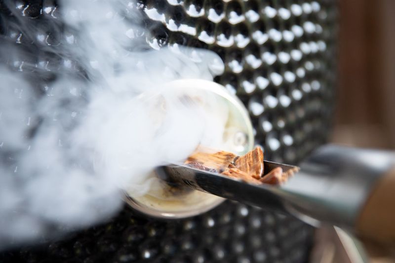 Putting wet smoke chips in the yakiniku kamado grill barbecue