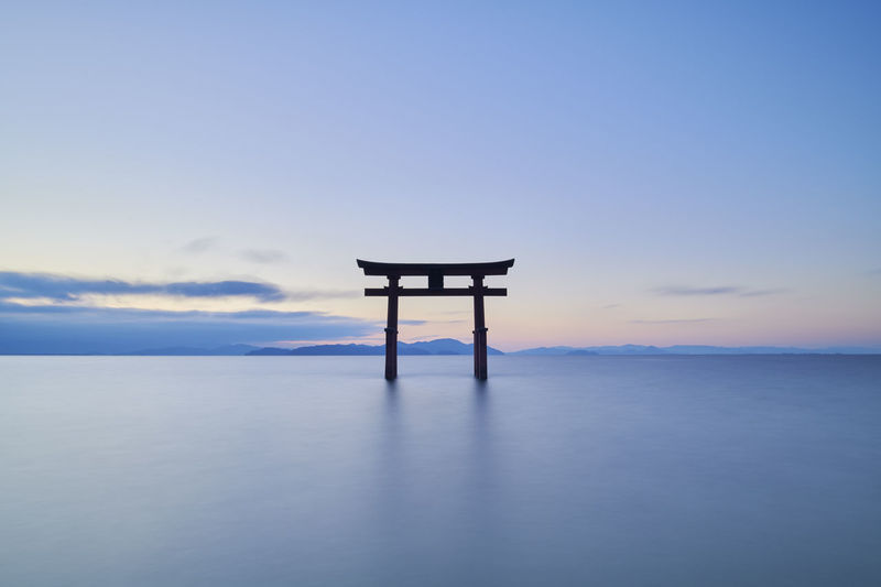 Long exposure shot of shirahige shrine torii gate at sunrise, lake biwa, shiga prefecture, japan