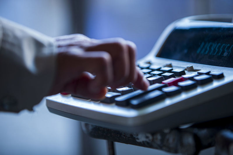 Close up of a person using a calculator
