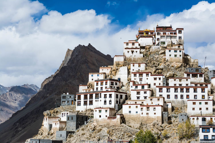 Low angle view of key monastery against cloudy sky
