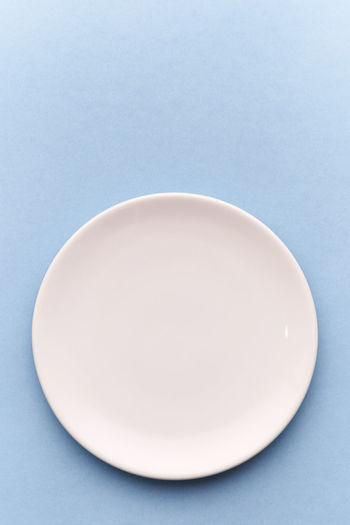 Directly above shot of plate on blue background