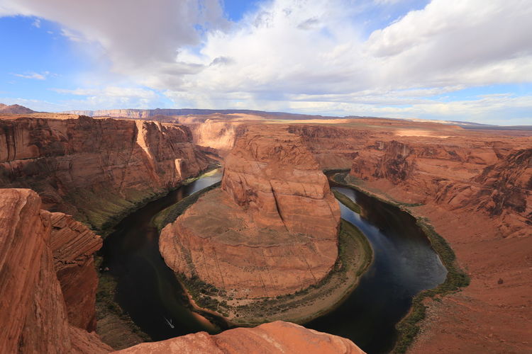 High angle view of horseshoe bend against cloudy sky