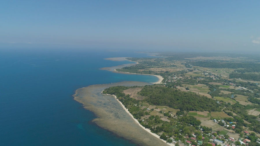 Aerial view of seashore with beaches, lagoons and coral reefs. philippines, luzon. 