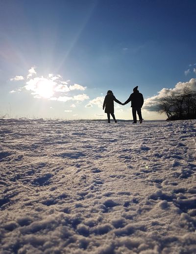 People walking on snow covered land