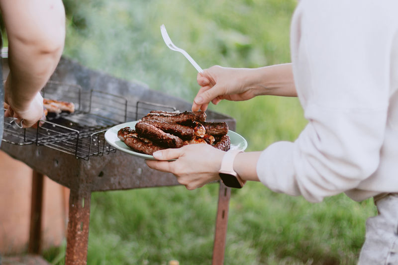 Midsection of man preparing food bbq 