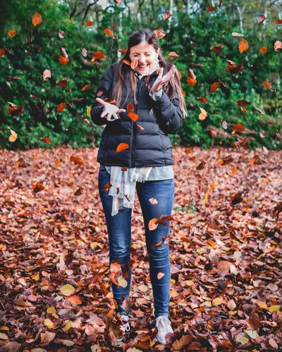 Young woman standing in forest