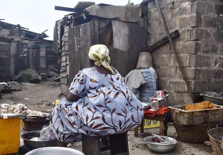 Rear view of woman cooking outdoors