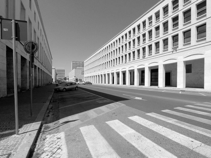 Street by road against buildings in city