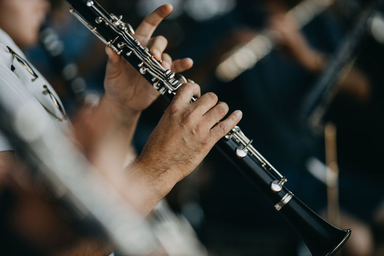 Close up man playing clarinet