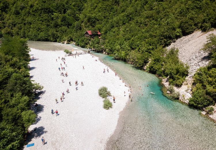 High angle view of people on river amidst trees