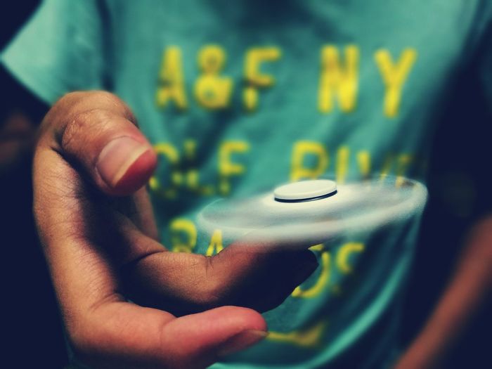 Close-up of hand holding fidget spinner