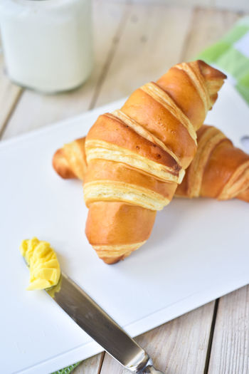 Close-up of croissants in plate on table