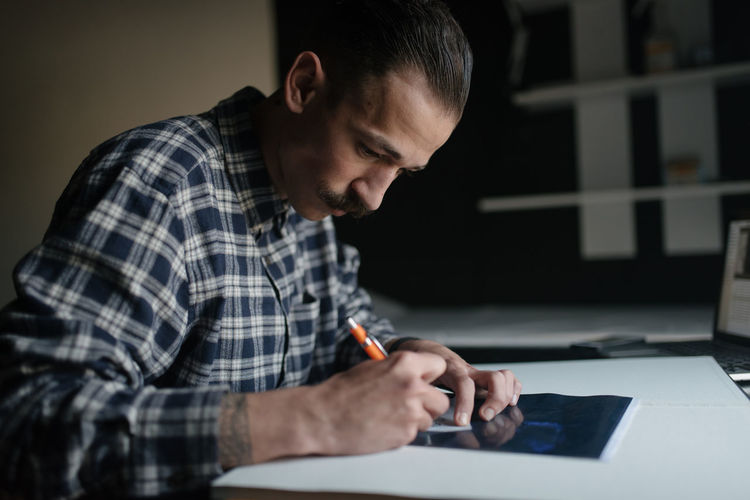 Tattoo artist working in his studio
