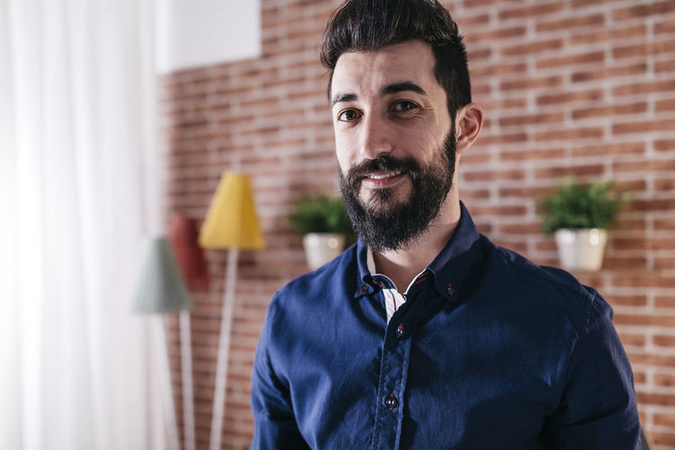Portrait of smiling man standing at home