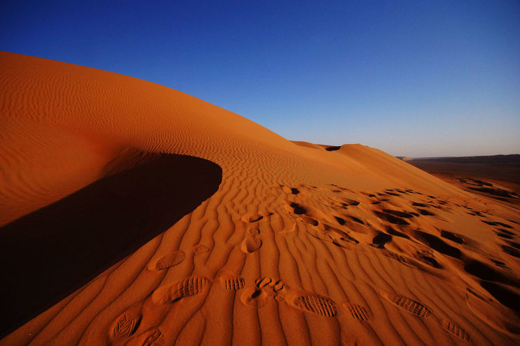 High angle view of footprints on sand dune