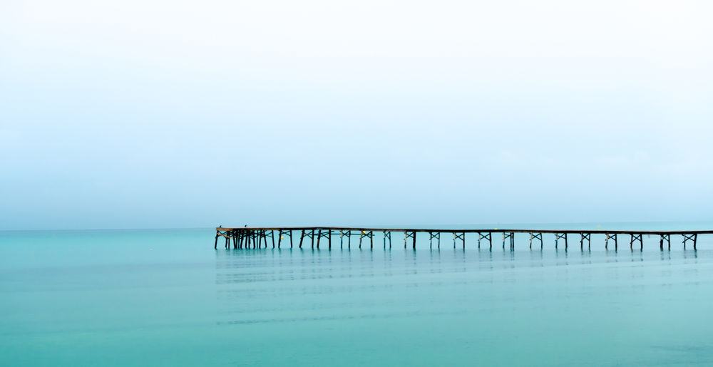 Pier over sea against sky