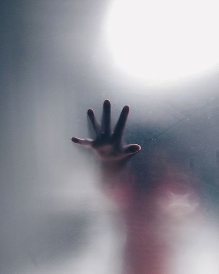 Close-up of baby hand on window