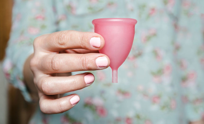 Midsection of woman holding menstrual cup
