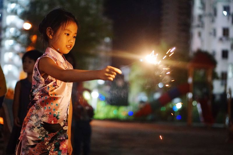 Young girl holding sparkler