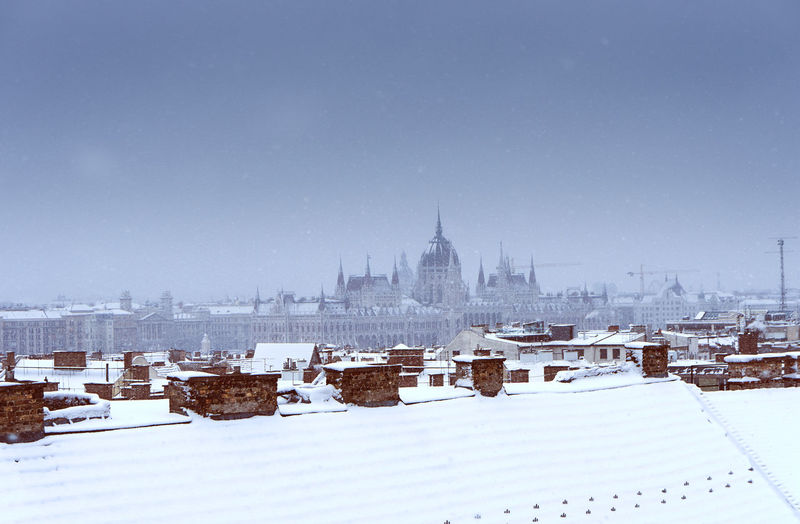 View of buildings against clear sky during winter