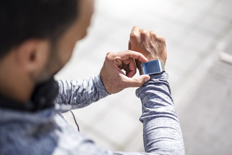 Close-up of athlete checking smartwatch