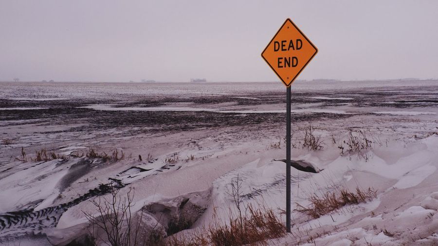 Dead end sign post on landscape