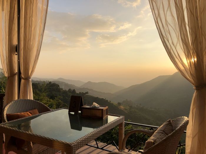 High angle view of chairs and tables against sky during sunset