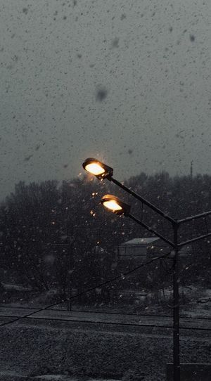 Illuminated street light on snow
