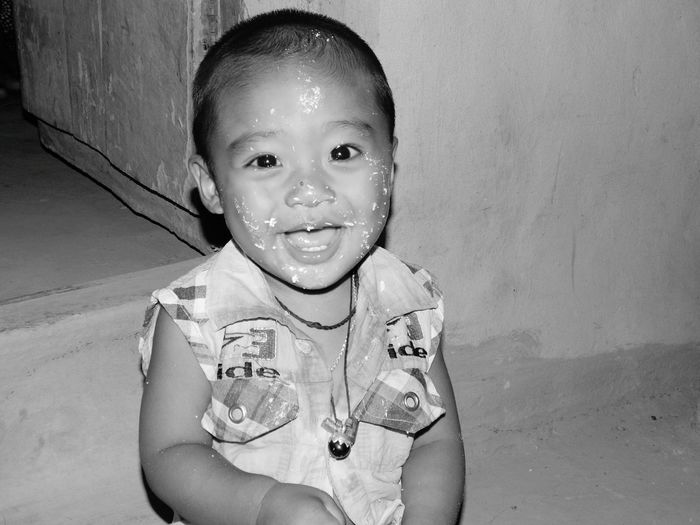 Portrait of smiling innocent boy with food on face