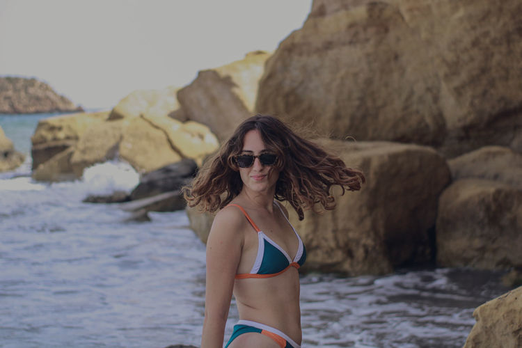 Portrait of young woman in sunglasses at beach